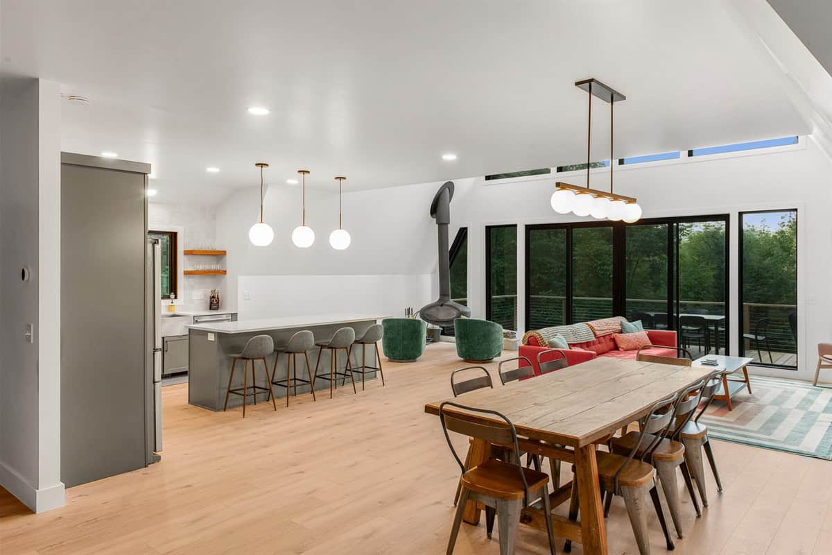 The Creekside bright great room with dining table and mountain views