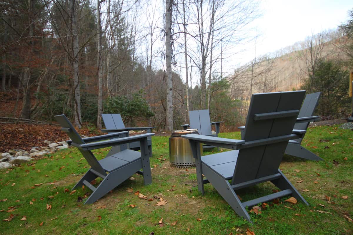 The Creekside fire pit in a wooded creekside mountain setting