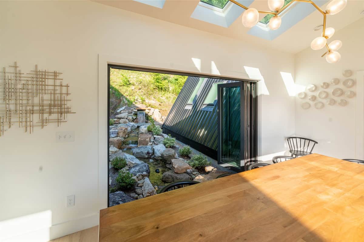 The Overlook dining room with accordion doors open to the water feature